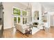 Bright, open living area with high ceilings, hardwood floors, and a cozy fireplace surrounded by built-in shelving at 10602 Country Squire Ct, Matthews, NC 28105