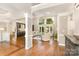 Bright living room with soaring ceilings, hardwood floors, and large windows for abundant natural light and elegant ambiance at 10602 Country Squire Ct, Matthews, NC 28105