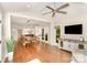 Open-concept living area with hardwood floors, a ceiling fan and natural light at 10602 Country Squire Ct, Matthews, NC 28105