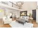 Open-concept living area featuring hardwood floors, high ceilings, and seamless flow to kitchen with custom cabinetry at 10602 Country Squire Ct, Matthews, NC 28105
