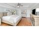 Light-filled main bedroom with hardwood floors, ceiling fan and neutral decor at 10602 Country Squire Ct, Matthews, NC 28105