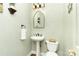 Well-lit powder room featuring pedestal sink, decorative mirror, and neutral wall color at 10602 Country Squire Ct, Matthews, NC 28105