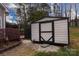 Outdoor shot of a shed next to a basketball court, set in a lush backyard, offering storage and recreation at 10928 Jardin Way, Charlotte, NC 28215