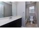 Well-lit bathroom featuring a large mirror, modern vanity, and combined shower and bathtub at 10928 Jardin Way, Charlotte, NC 28215