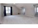 Spacious bonus room with neutral walls, carpet flooring and large windows, perfect for flexible living at 10928 Jardin Way, Charlotte, NC 28215
