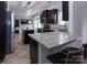 Gourmet kitchen with an island, granite counters, stainless appliances, and access to the dining area at 10928 Jardin Way, Charlotte, NC 28215