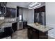 A spacious kitchen featuring stainless steel appliances, dark wood cabinets, and granite countertops at 10928 Jardin Way, Charlotte, NC 28215