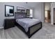 Spacious main bedroom with a well-appointed bed, carpet, and a glimpse into the luxurious bathroom at 10928 Jardin Way, Charlotte, NC 28215