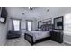 Serene main bedroom featuring plush bedding, soft gray tones, and abundant natural light at 10928 Jardin Way, Charlotte, NC 28215