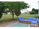 Inviting backyard patio area with a plush blue outdoor sofa and views of the lawn at 11621 Red Knoll Ln, Pineville, NC 28134