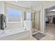 This light-filled bathroom has a soaking tub, separate shower, and access to a walk-in closet at 11621 Red Knoll Ln, Pineville, NC 28134