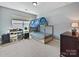 This bedroom is bright with a large window and has playful furnishings and decor at 11621 Red Knoll Ln, Pineville, NC 28134