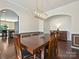 Dining room with wood table and chairs, modern lighting, and access to the kitchen at 11621 Red Knoll Ln, Pineville, NC 28134