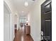 Inviting foyer featuring hardwood floors, white walls and decorative lighting with an archway leading to other rooms at 11621 Red Knoll Ln, Pineville, NC 28134