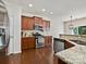 Well-equipped kitchen featuring stainless steel appliances, granite countertops and dark wood flooring at 11621 Red Knoll Ln, Pineville, NC 28134