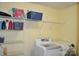This laundry room features a washer, dryer, shelves, and ample storage space for supplies at 11621 Red Knoll Ln, Pineville, NC 28134