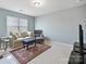 This living room features a comfortable sofa, accent chair, and a colorful rug at 11621 Red Knoll Ln, Pineville, NC 28134