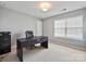 This home office features a modern desk, a comfortable chair, and a large window at 11621 Red Knoll Ln, Pineville, NC 28134