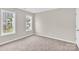 Neutral bedroom featuring plush carpet, gray walls, and double windows at 119 Tilton Dr, Mooresville, NC 28115