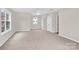 Spacious carpeted bedroom featuring a ceiling fan and natural light at 119 Tilton Dr, Mooresville, NC 28115