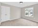 Neutral carpeted bedroom featuring gray walls and double-door closet at 119 Tilton Dr, Mooresville, NC 28115