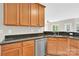 Granite countertops and stainless-steel dishwasher in kitchen with wood cabinets at 119 Tilton Dr, Mooresville, NC 28115