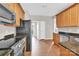 Well-lit kitchen features stainless appliances, granite counters, and wood floors at 119 Tilton Dr, Mooresville, NC 28115