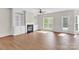 Open living room features hardwood floors, fireplace, built-ins, and lots of light at 119 Tilton Dr, Mooresville, NC 28115