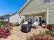 Back porch area with nice landscaping and outdoor seating at 121 Hanks Bluff Dr, Mooresville, NC 28117