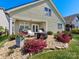View of the back yard and covered porch with great landscaping at 121 Hanks Bluff Dr, Mooresville, NC 28117