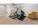 Basement gym with exercise equipment, neutral carpet, ceiling fan, and a comfortable armchair at 121 Hanks Bluff Dr, Mooresville, NC 28117