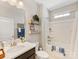 Bright bathroom featuring a shower-tub, vanity and decorative shelves at 121 Hanks Bluff Dr, Mooresville, NC 28117