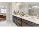 Bathroom vanity featuring double sinks, dark wood cabinetry, and ample countertop space at 121 Hanks Bluff Dr, Mooresville, NC 28117