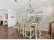 Bright dining room featuring a modern chandelier, a table with seating, and large windows at 121 Hanks Bluff Dr, Mooresville, NC 28117