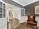 Elegant entryway with hardwood floors, staircase, and a stylish leather chair at 121 Hanks Bluff Dr, Mooresville, NC 28117