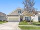 Charming single-Gathering home with a two-car garage, manicured lawn, and mature tree at 121 Hanks Bluff Dr, Mooresville, NC 28117
