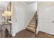 Hallway featuring hardwood floors, staircase, and white doors with a view to an upper floor at 121 Hanks Bluff Dr, Mooresville, NC 28117