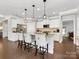 Modern kitchen island with pendant lighting and stainless steel appliances at 121 Hanks Bluff Dr, Mooresville, NC 28117