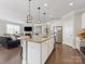 Open-concept kitchen with island, stainless steel appliances, and view of the living room at 121 Hanks Bluff Dr, Mooresville, NC 28117