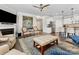 Open concept living room with a fireplace, stylish furniture, and hardwood floors at 121 Hanks Bluff Dr, Mooresville, NC 28117