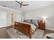 Spacious main bedroom with a ceiling fan, a wooden sleigh bed, and a decorative rug at 121 Hanks Bluff Dr, Mooresville, NC 28117