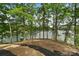 Scenic view of the tranquil lake surrounded by lush trees from the backyard at 121 Rhinehill Dr, Mooresville, NC 28117