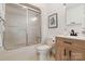 Well-lit bathroom features tub with sliding door, modern vanity, and neutral decor at 121 Rhinehill Dr, Mooresville, NC 28117
