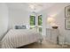 Bright bedroom with neutral tones, decorative pillows, and outdoor views through the window at 121 Rhinehill Dr, Mooresville, NC 28117