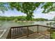 Relaxing deck overlooking the lake, surrounded by trees and showcasing waterfront views at 121 Rhinehill Dr, Mooresville, NC 28117
