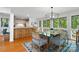 Open concept dining area with breakfast bar, seating for six, and modern chandelier at 121 Rhinehill Dr, Mooresville, NC 28117