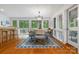Bright dining room with modern chandelier, seating for six, and outdoor views through large windows at 121 Rhinehill Dr, Mooresville, NC 28117