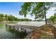 Scenic lake view featuring a weathered wooden dock, perfect for enjoying waterfront living at 121 Rhinehill Dr, Mooresville, NC 28117