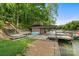 Lakefront property showcasing a multi-level deck, dock, and boat storage for waterside enjoyment at 121 Rhinehill Dr, Mooresville, NC 28117
