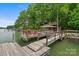 Dock with a boathouse and seating, offering stunning views of the lake at 121 Rhinehill Dr, Mooresville, NC 28117